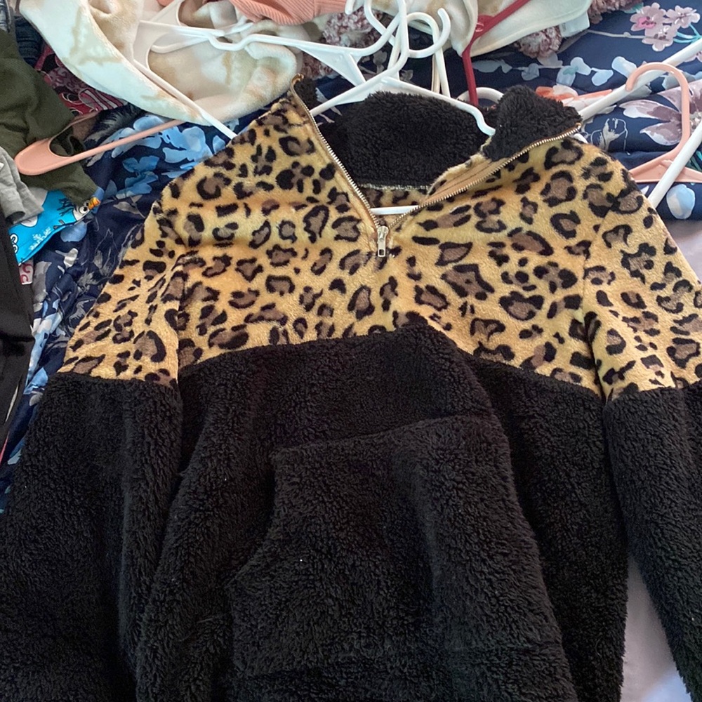 i don’t know the brand but it’s a small zip up sweater cheetah print fuzzy
